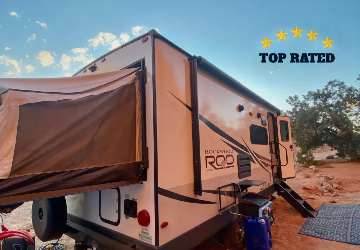 Top-rated RV rental: a white Rockwood Roo travel trailer with a pop-out tent, perfect for your outdoor camping trip.. Forest River Rockwood Roo 2021