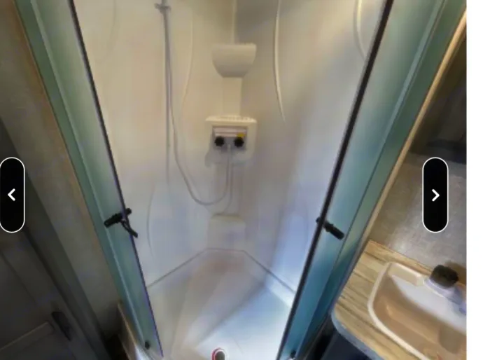 This RV rental features a bright, clean shower stall with glass doors and a small sink, perfect for your travels.. Crossroads RV Volante 2021