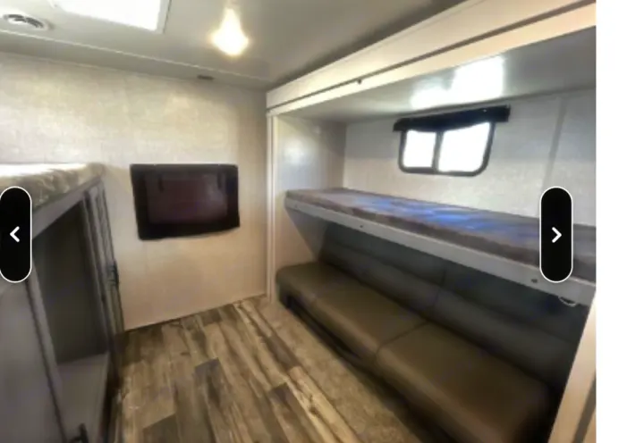 RV rental bunkhouse featuring comfortable bunk beds and a sofa seating area, ideal for family adventures.. Crossroads RV Volante 2021