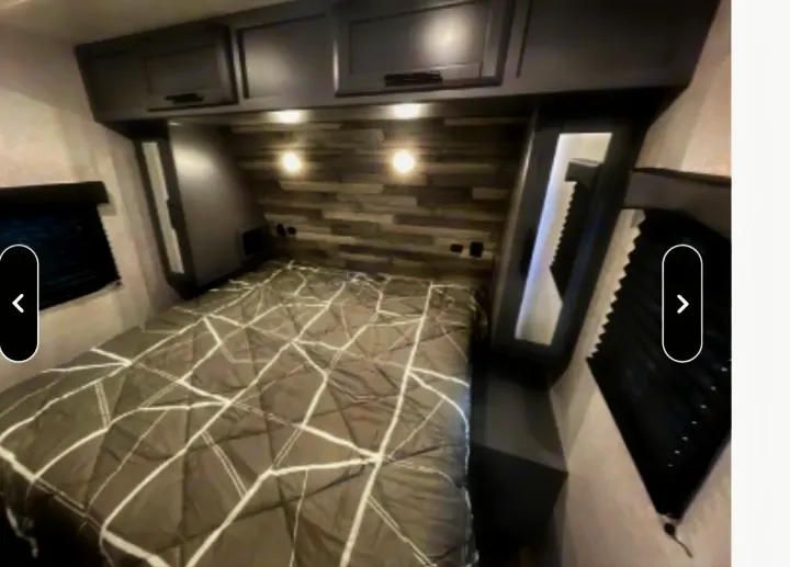 Cozy RV rental bedroom with a comfy bed, stylish headboard, and overhead cabinets for storage during your travels.. Crossroads RV Volante 2021