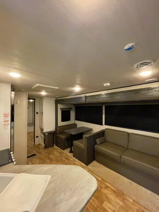 Explore this comfortable RV rental: modern living space with sofa, dinette, and functional kitchen.. Keystone RV Hideout 2022