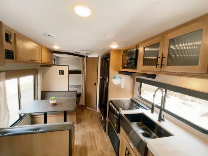 Bright RV rental with full kitchen, dinette, and rear bunk beds. Modern, light wood interior, ideal for travel.. Cherokee MKSE22 2023