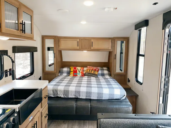 Spacious RV rental interior with a cozy bedroom, fully equipped kitchen, and storage for travel comfort.. Cherokee MKSE22 2023