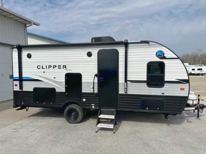 A sleek, light-colored Clipper travel trailer RV is parked on asphalt, ideal for an rv rental getaway. It has black trim & door.. Coachmen Clipper 182DBU 2022