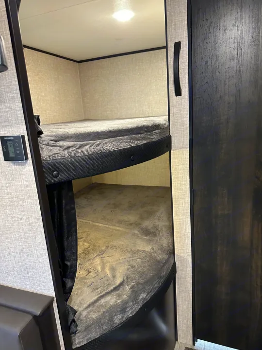 Step into this RV rental's cozy bunk area featuring two beds & Dometic climate control for comfortable adventures.. Jayco Jay Flight SLX 2022