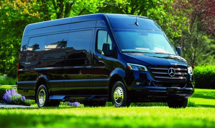 Black Mercedes-Benz Sprinter van on a lush green lawn. Ideal for a spacious and luxurious RV rental experience.. Ultimate Toys Ultimate RV 2023