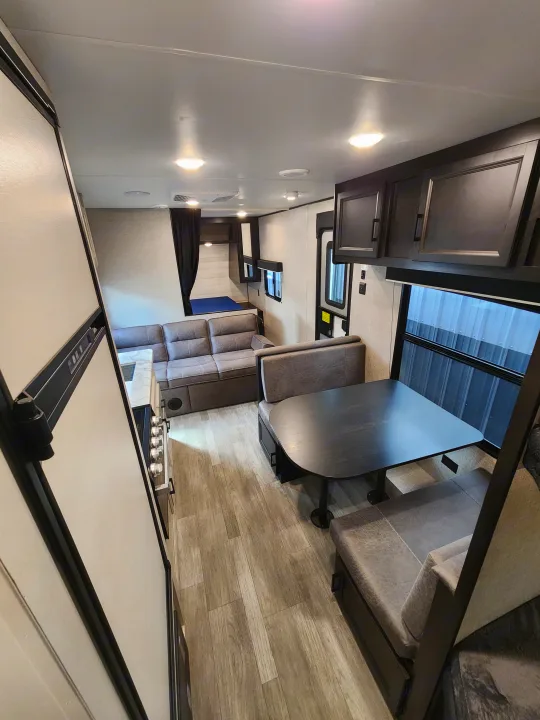 Spacious RV rental with panoramic windows, a dining booth, kitchen, and comfortable living area.. Jayco Jay Flight 2023