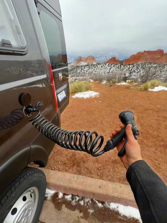 Outdoor shower from an RV rental van in snowy Garden of the Gods, Colorado.. Dodge Ram Promaster 2500 2022