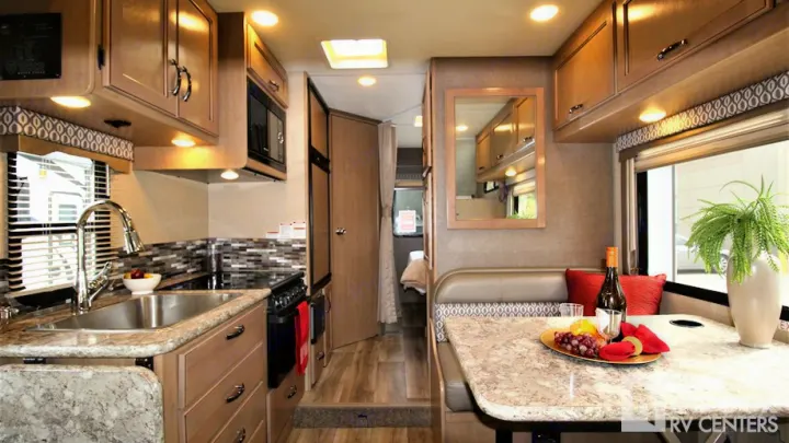 An RV rental interior with a well-equipped kitchen, comfortable dinette, and bright living area, ready for adventure.. Thor Motor Coach Freedom Elite 2018