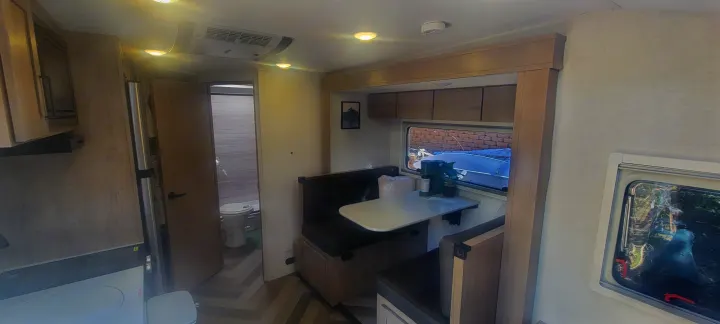This rv rental offers a well-equipped kitchen, dinette, and private bathroom in a light, modern interior.. Ember Overland 2023