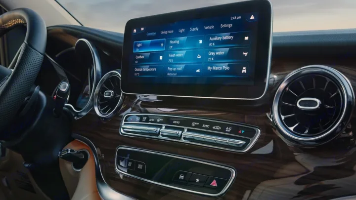 Modern RV rental dashboard with large digital screen displaying camper controls for lights, water, and pop-up roof status.. Mercedes Class V Marco Polo 2023