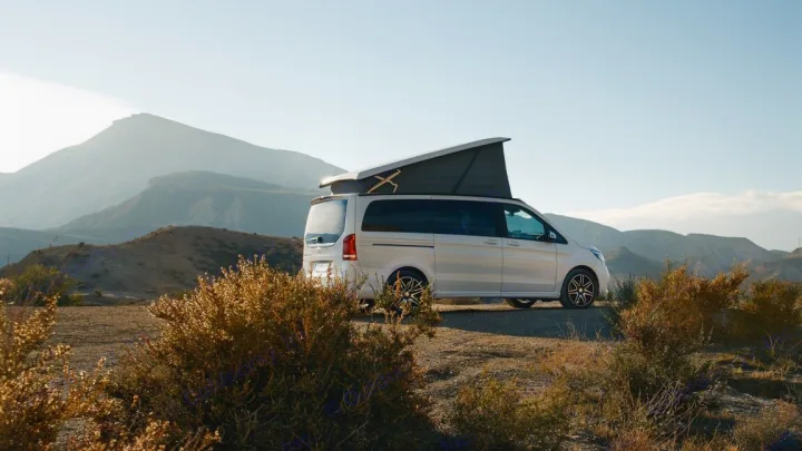 Modern pop-top Mercedes camper van parked in a vast mountainous landscape, perfect for an rv rental.. Mercedes Class V Marco Polo 2023