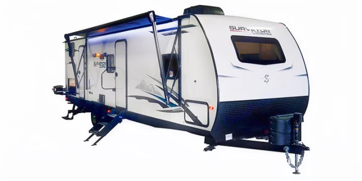 This white travel trailer recreational vehicle, featuring an awning & steps, is ideal for your next rv rental camping trip.. Forest River Surveyor 2021