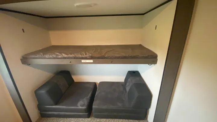 RV rental interior: cozy bunk bed above modular seating, perfect for kids or extra guests. Max weight 275 lbs.. Cruiser Rv Corp Cruiser 2021