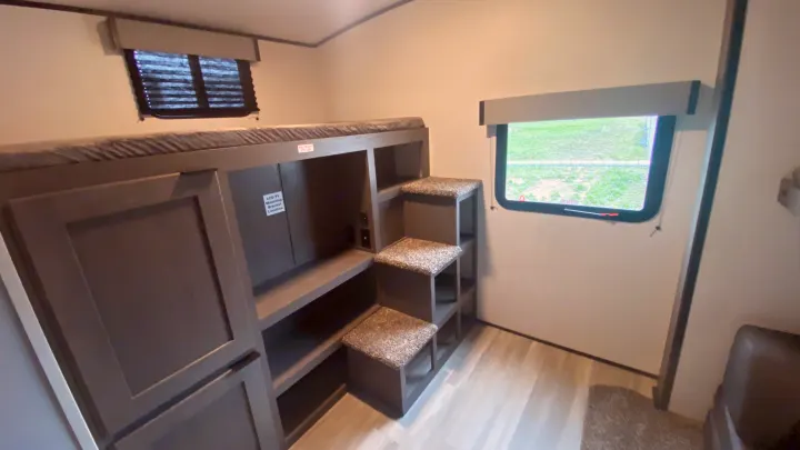 RV rental bunkhouse: lower bunk, carpeted steps, shelves & two windows for a spacious camper interior.. Cruiser Rv Corp Cruiser 2021