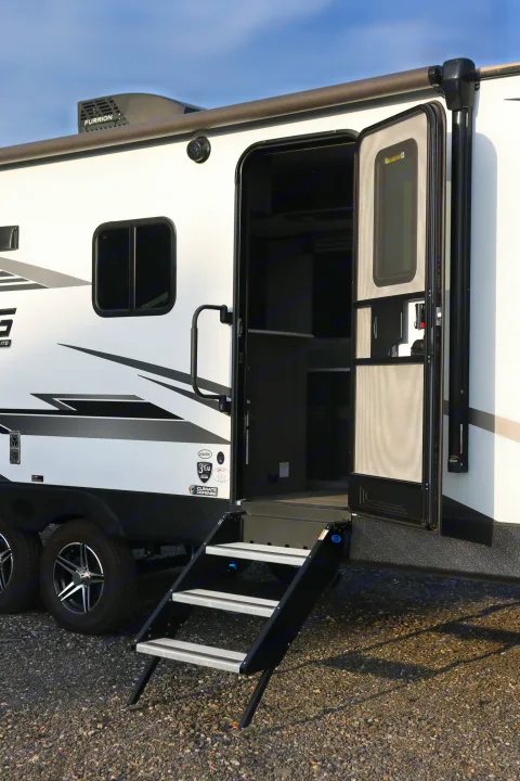 This white RV rental shows its open entry door with extended steps and a side awning, ready for adventure.. Cruiser RV MPG Ultra Lite 2022
