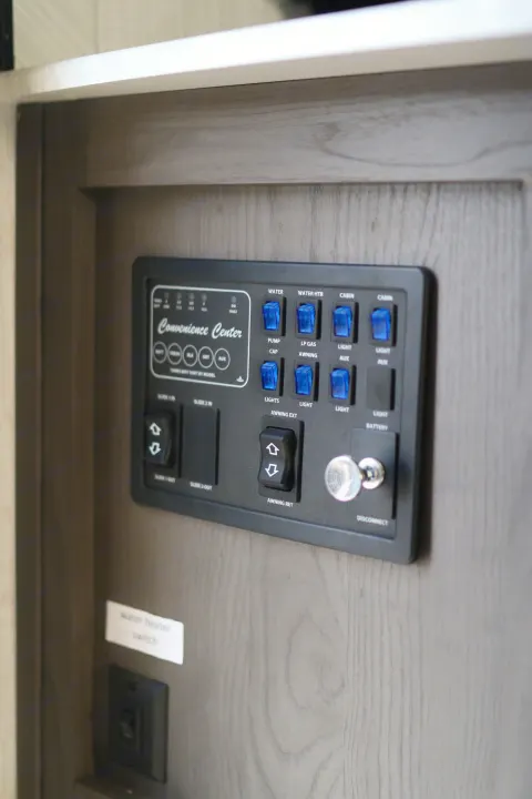 RV rental control panel: the "Convenience Center" with switches for water, lights, awning, and slide-outs.. Cruiser RV MPG Ultra Lite 2022