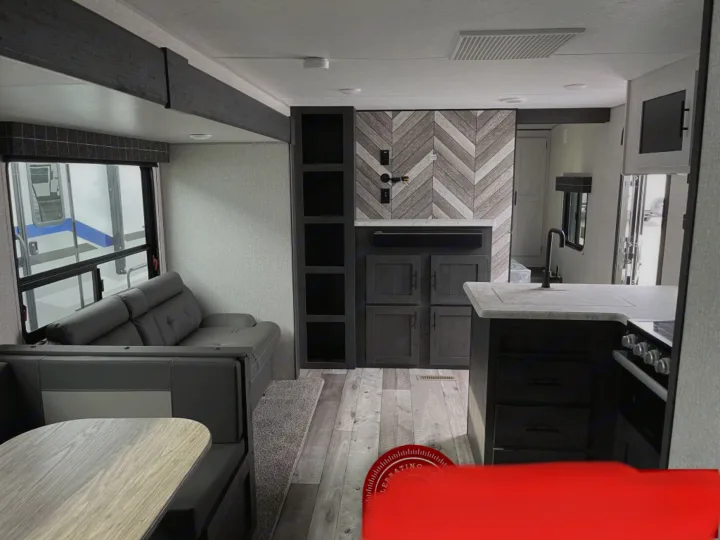 Modern RV rental interior showcasing a comfortable living space, dinette, kitchen, and stylish chevron wall.. K-Z Manufacturing Sportsman Classic 2022