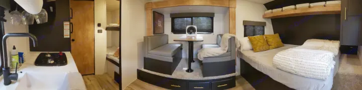 Panoramic RV rental view: sleek kitchen, comfy dinette, main bed, and bunk beds for a versatile adventure.. Keystone RV Springdale 2022