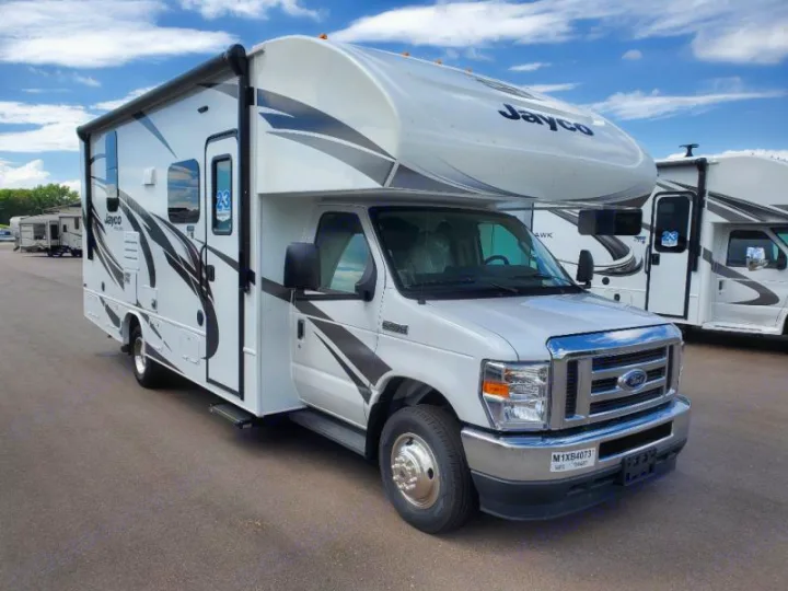 This white Jayco Class C motorhome is available for RV rental. Parked outside with bold graphics, perfect for adventures.. Jayco Redhawk 2021