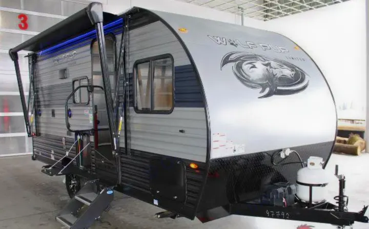 Gray Wolf Pup travel trailer with extended awning, ready for your next RV rental adventure.. Forest River Cherokee Wolf Pup 2022