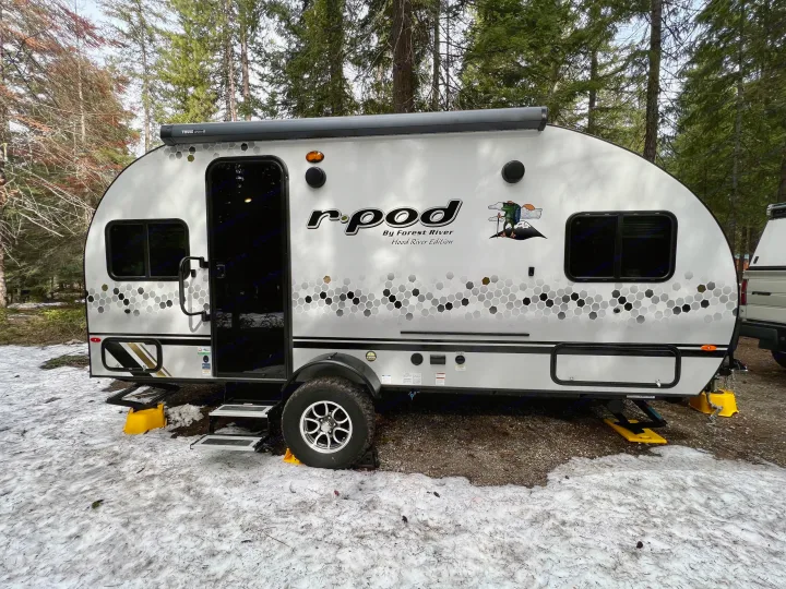 White r-pod travel trailer RV rental at a snowy forest campsite, ready for an outdoor adventure.. Forest River R-Pod RP-190 2021