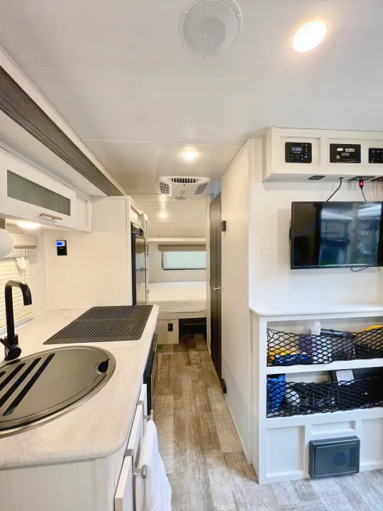 Inside an rv rental: compact kitchen, bedroom, and living space. Modern, functional design for travel.. Forest River R-Pod RP-190 2021
