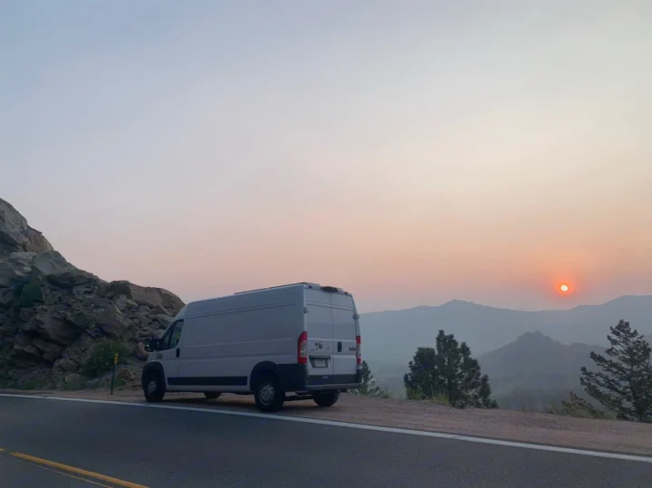 An RV rental van overlooks a hazy mountain sunset. Perfect for a scenic road trip adventure.. Other Sprinter Van 2017