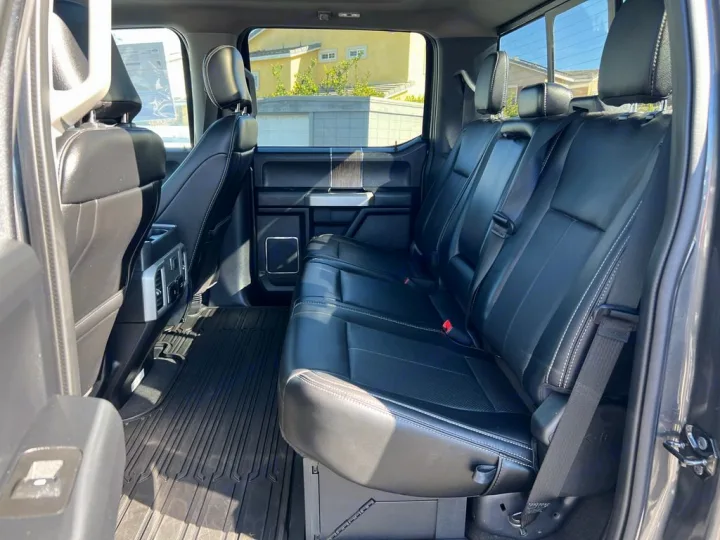 Clean, spacious truck interior: black leather rear seats, durable floor mats. Ideal comfort for any RV rental journey.. Ford F350 Diesel Double Cab 2020