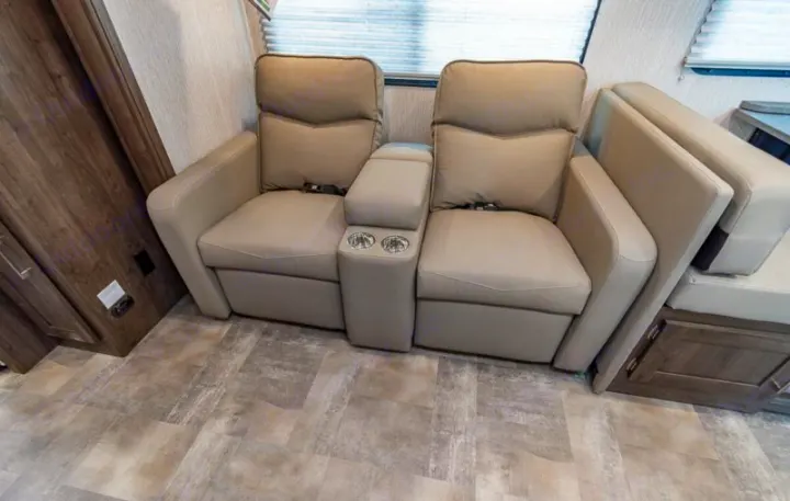 Experience comfort in this RV rental with beige theater recliners, a center console, and cup holders. Perfect for your journey.. Coachmen Pursuit 2022