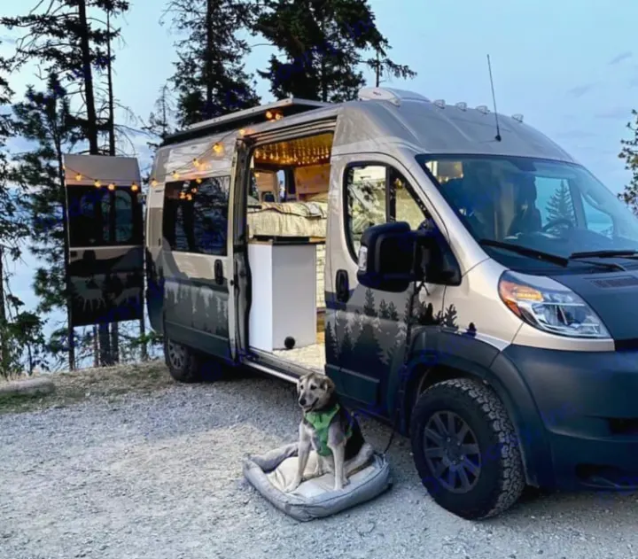 This RV rental offers scenic adventures! A dog relaxes outside a camper van with its door open, revealing a cozy interior.. Dodge Ram 1500 2020