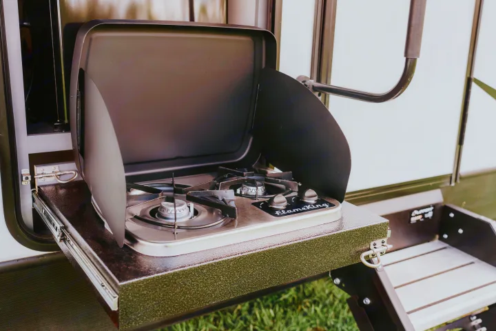RV rental essential: This pull-out outdoor kitchen features a two-burner FlameKing stove, perfect for camp cooking.. Other Other 2023
