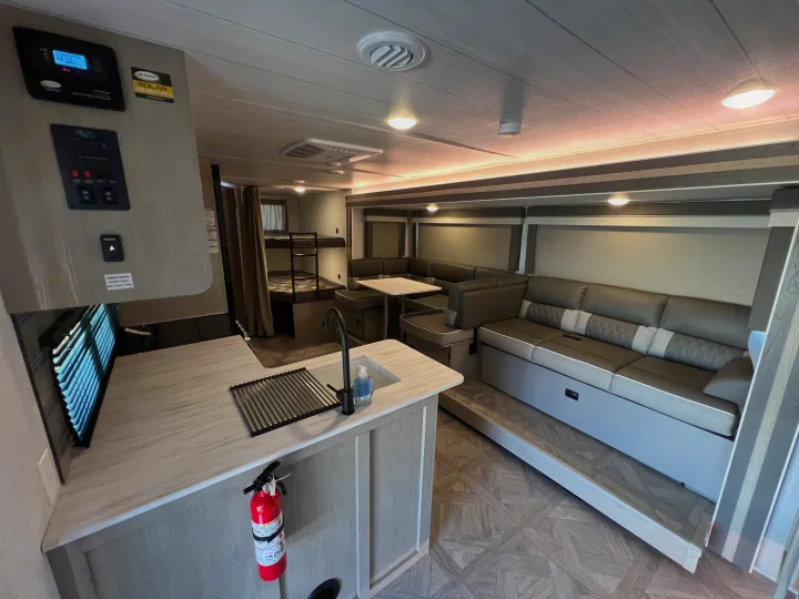 Spacious RV rental with a modern kitchen, U-shaped dinette, and bunk beds, perfect for family travel.. Forest River Salem cruise lite 2023