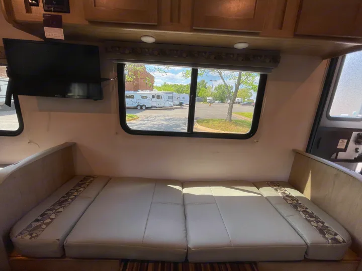 RV rental interior features comfortable bench seating, a TV, and a window with an outdoor view. Perfect for travel.. Forest River R-Pod 2021
