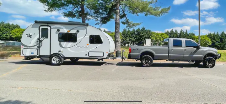 A dark gray pickup truck towing a gray 'r-pod' travel trailer. Ready for your next RV rental adventure!. Forest River R-Pod 2021