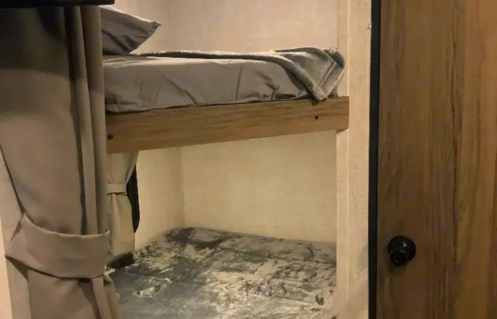 Cozy RV rental bunk beds, ideal compact sleeping for travel and family camping trips.. Gulf Stream Ameri-Lite 2022