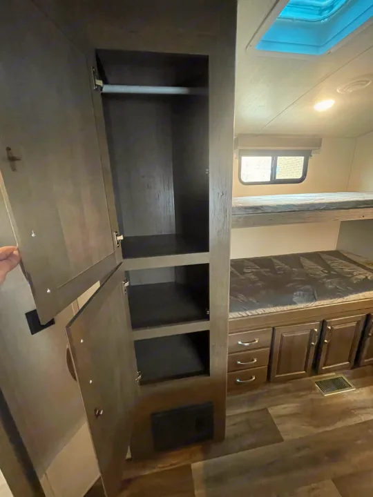 Inside this RV rental: spacious wardrobe, cozy bunk beds, and ample storage for your next adventure.. Keystone Cougar 2023