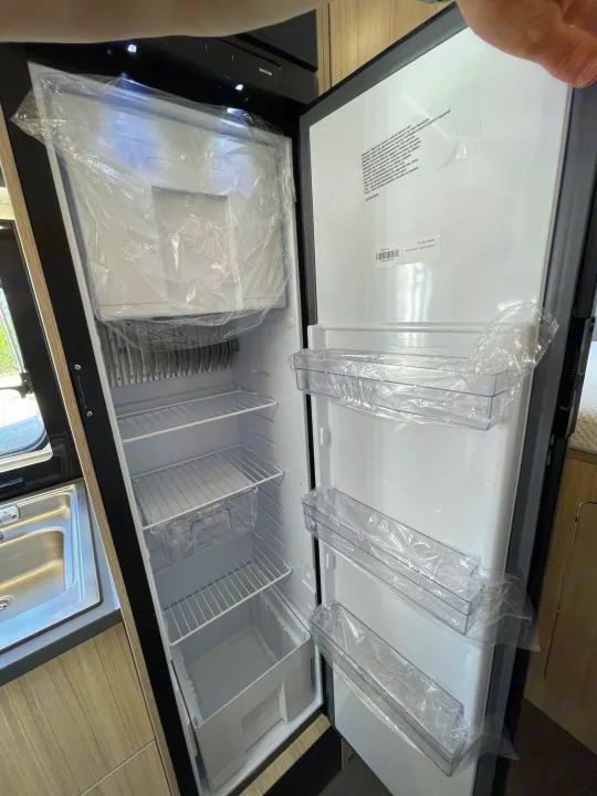 RV rental: Brand new refrigerator interior, all shelves and door bins still in protective plastic.. SunLiving A 75 DP 23 2023