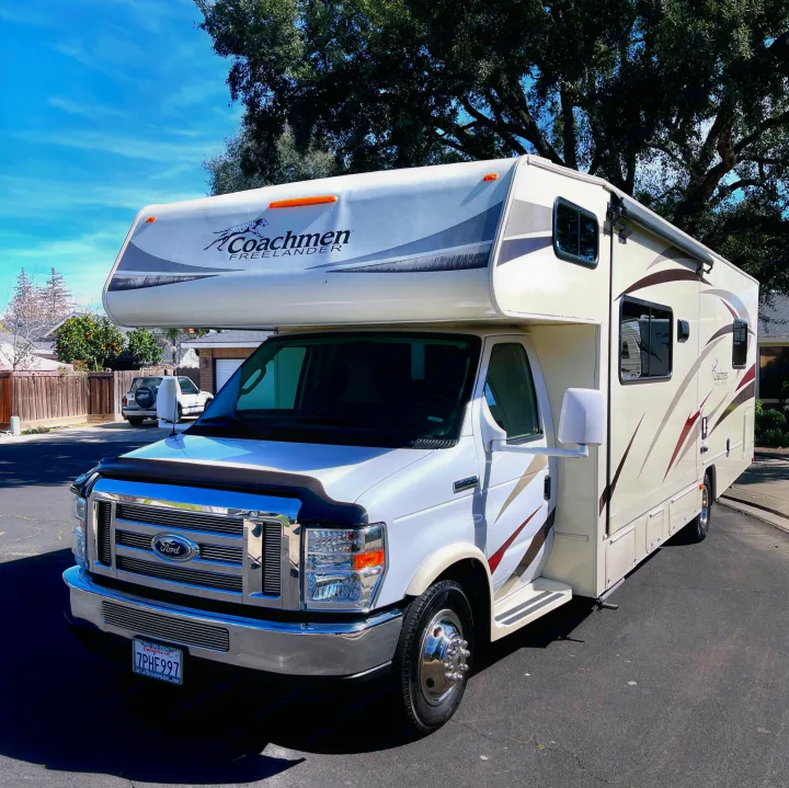 Pristine white Coachmen Freelander Class C motorhome rv rental, parked under a bright blue sky, ready for your next adventure.. Other Other 2016