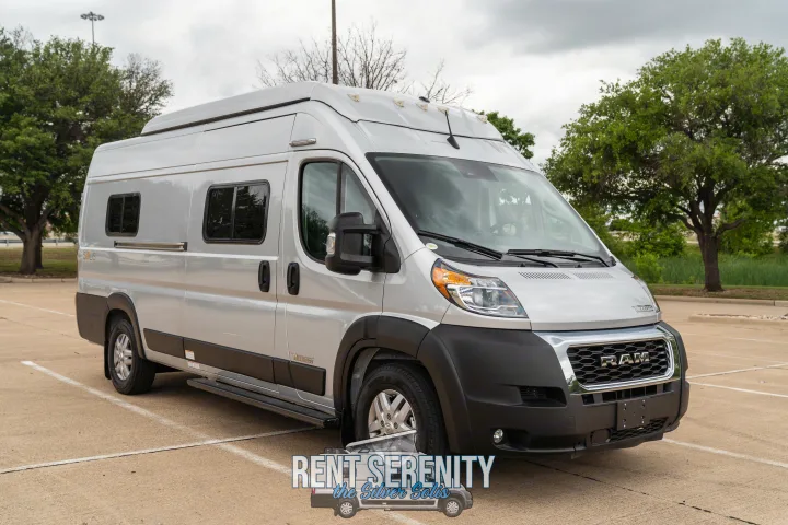 RV rental: A sleek, silver Winnebago Solis camper van, parked on a paved lot, under a cloudy sky, ready for travel.. Winnebago Solis 2023