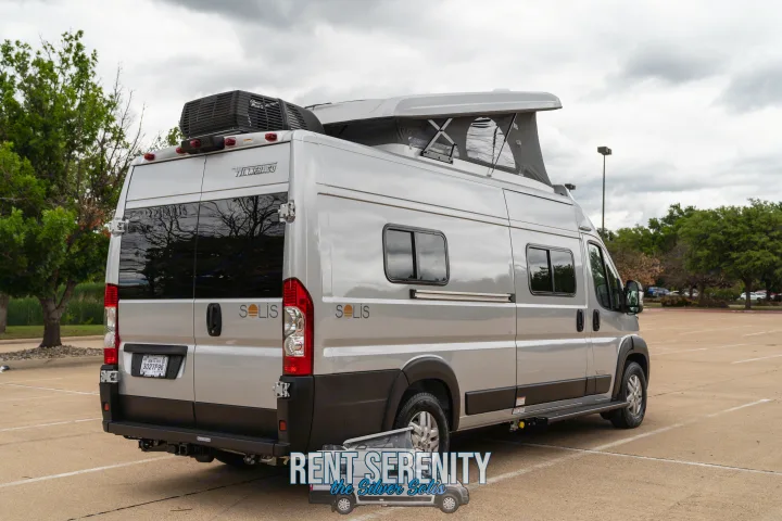 Explore the open road in this sleek silver Winnebago Solis RV rental, featuring a pop-top roof for extra space.. Winnebago Solis 2023