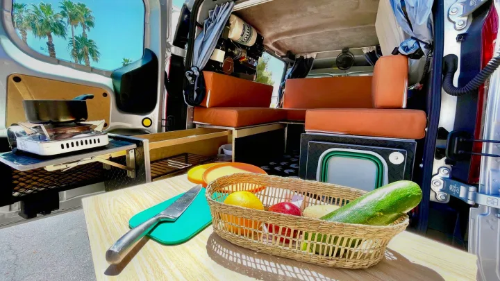 RV rental interior: Mobile kitchen with stove & dining area. Perfect for van life cooking under palm trees.. Ford transit connect 2022