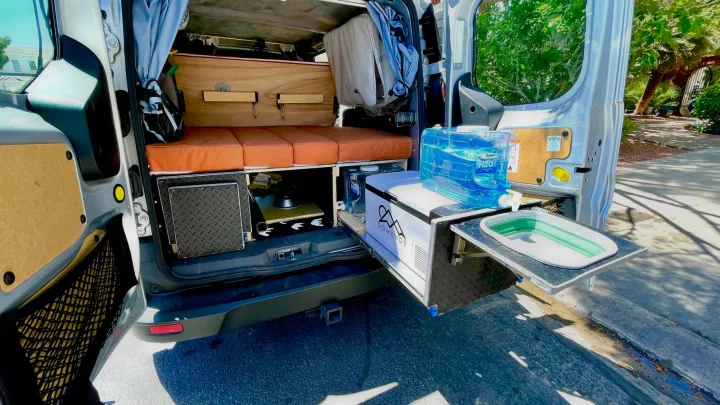 RV rental: Custom camper van with pull-out kitchen, fridge, bed, and sink. Perfect for van life adventures!. Ford transit connect 2022