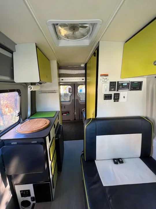 This bright **rv rental** showcases its well-equipped kitchen area, comfortable bench seating, and essential power controls.. Winnebago Mercedes Sprinter 2019