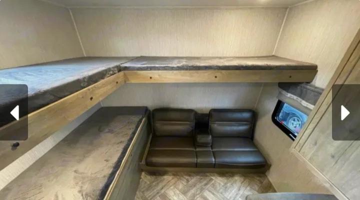 RV rental bunkhouse: L-shaped top bunk, lower bunk, and sofa with cup holders. Ready for family adventures!. Forest River Palomino Puma 2023