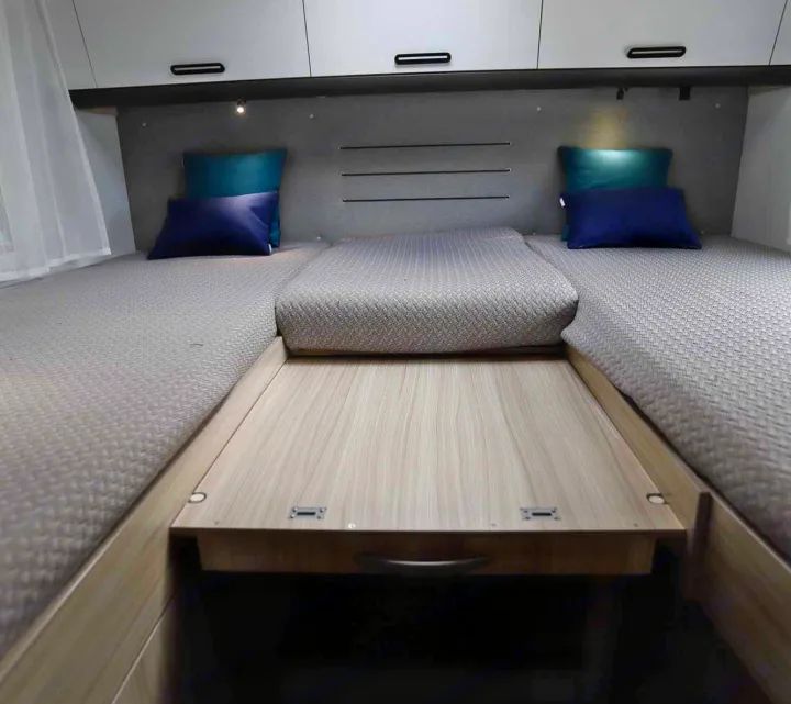 RV rental bedroom with two comfortable single beds, a convertible middle extension, and overhead storage for travel comfort.. SunLiving S 72 DL 2023