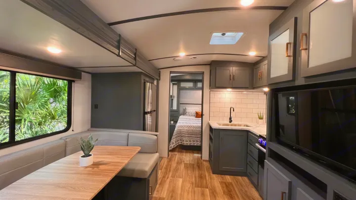Modern RV rental interior: spacious kitchen, bedroom, dinette, and large window view.. Keystone RV Bullet Ultra Lite 2022