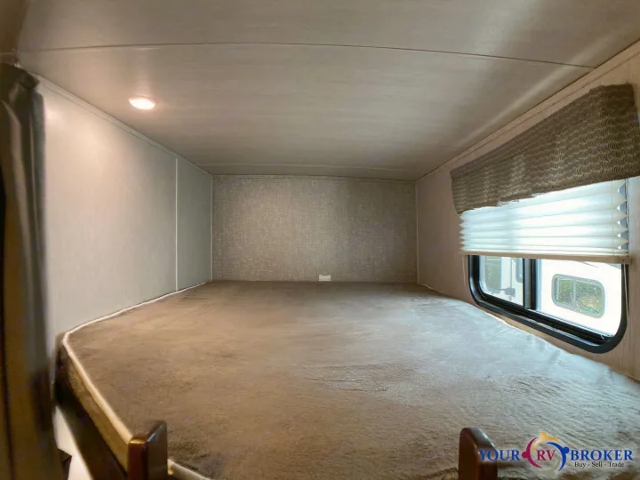 Comfortable RV rental bunk bed space with cozy mattress, window, blinds, and ceiling light. Perfect for travel.. Heartland RVs Mallard 2019