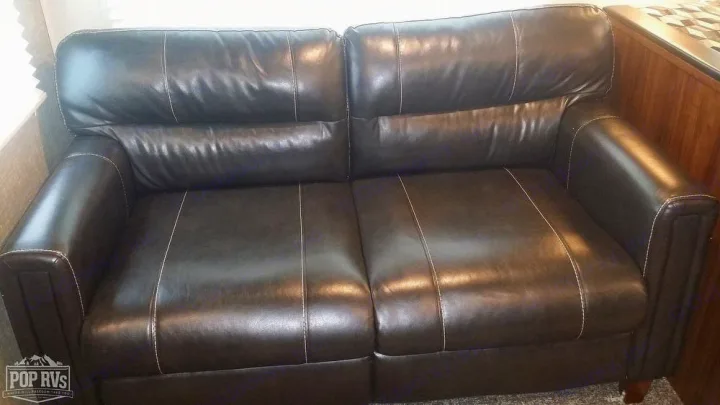 Plush dark brown leather sofa in an RV, offering comfortable seating for your next RV rental.. Heartland RVs Mallard 2019