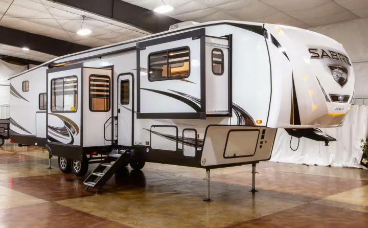 Spacious Sabre Cobalt fifth-wheel RV, ideal for an rv rental adventure, showcasing extended slide-outs & modern design.. Forest River Sabre 2022